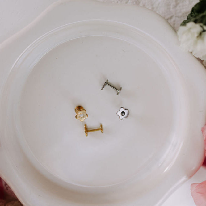 Three small metal objects on a white plate