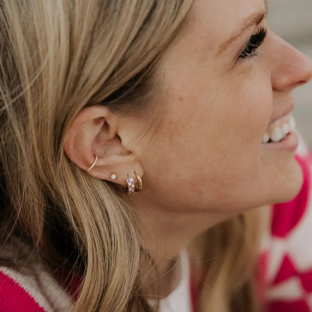 Close-up of a woman wearing earrings with a blurred background