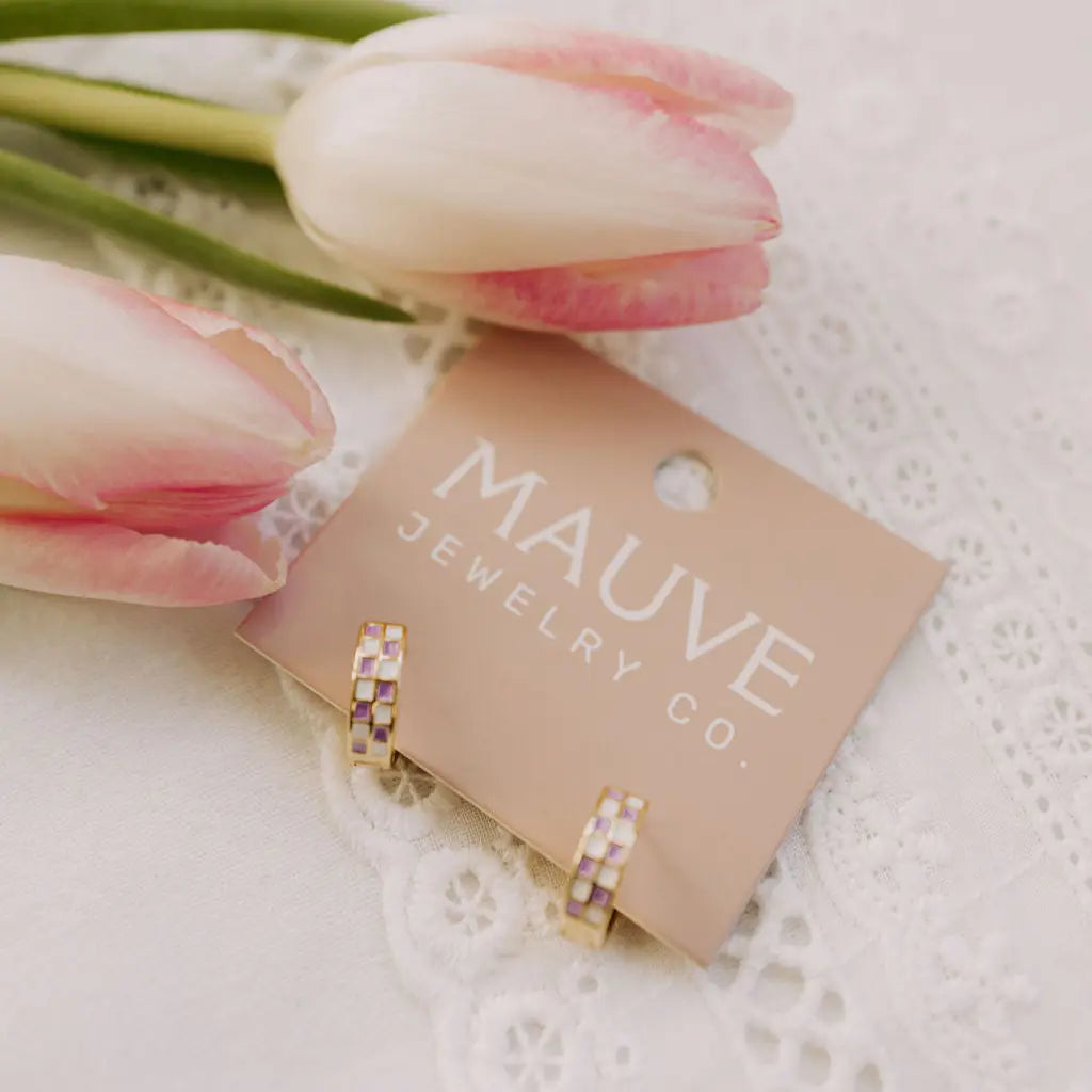 Jewelry card with earrings and pink tulips on a lace background, featuring 'MAUVE JEWELRY CO.'