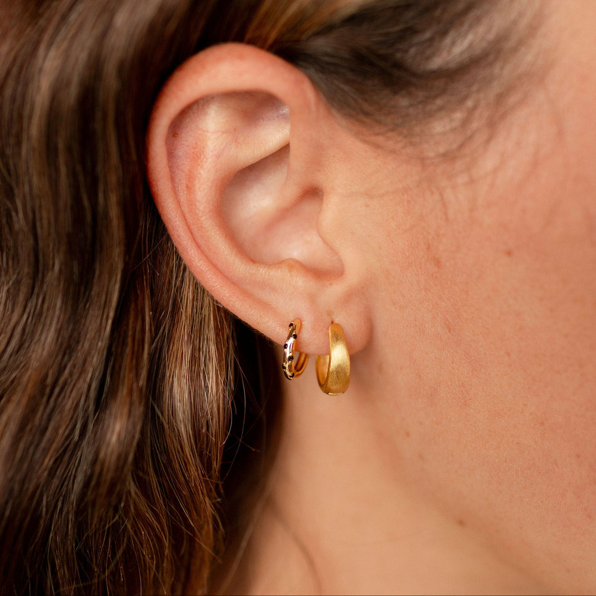 Girl wearing two hoop earrings