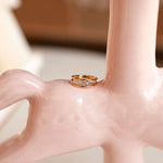 Gold ring on a pink ceramic vase