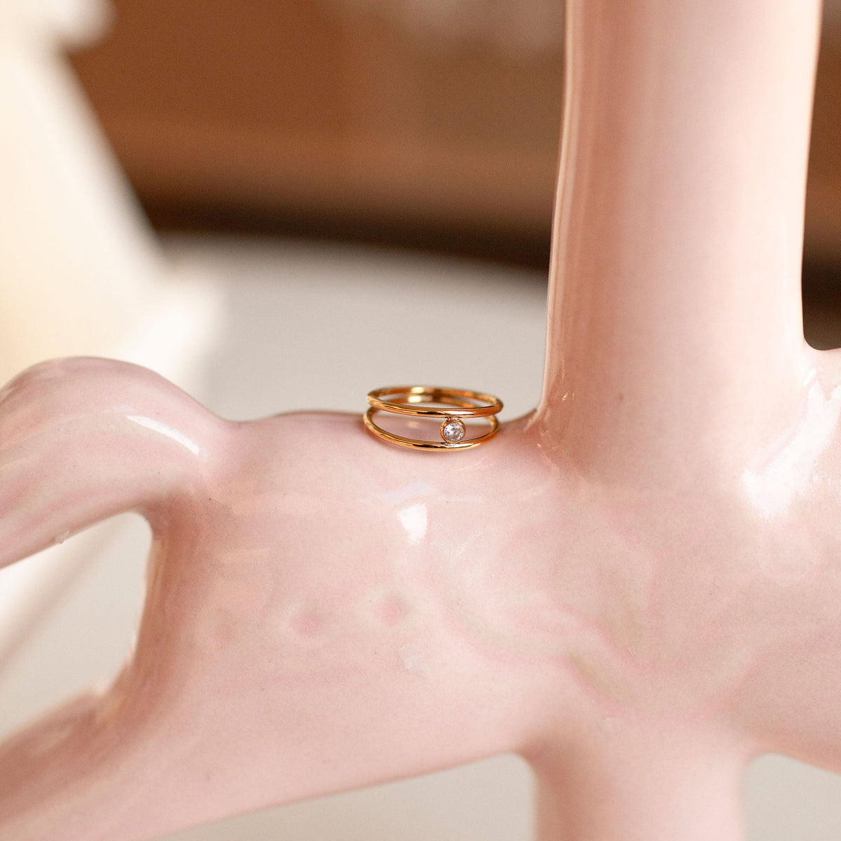 Gold ring on a pink ceramic vase