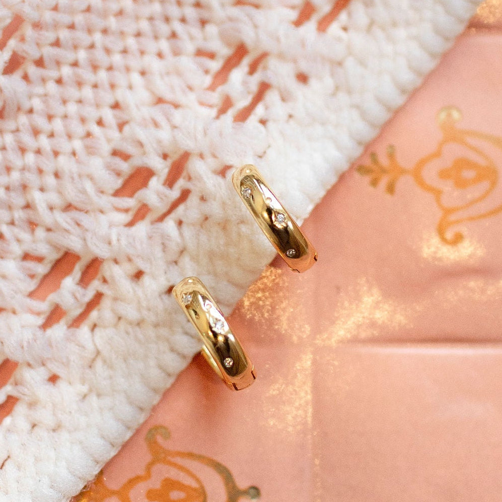 Close-up of a pink fabric with gold embroidery and lace detailing