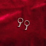 Load image into Gallery viewer, Silver hoop earrings on a red textured fabric background
