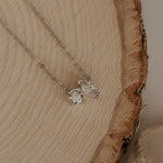 Load image into Gallery viewer, Silver necklace with a heart-shaped pendant on a wooden surface
