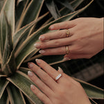Load image into Gallery viewer, Close-up of hands with rings on a plant
