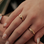 Load image into Gallery viewer, Close-up of a hand wearing two gold rings with a blurred background
