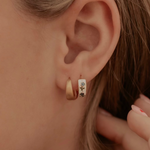 Load image into Gallery viewer, Close-up of an ear wearing a small hoop earring with a decorative center.
