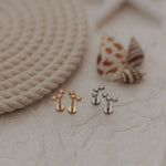 Load image into Gallery viewer, Set of small earrings on a textured surface with rope and shells in the background
