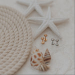 Sun earrings on a textured surface