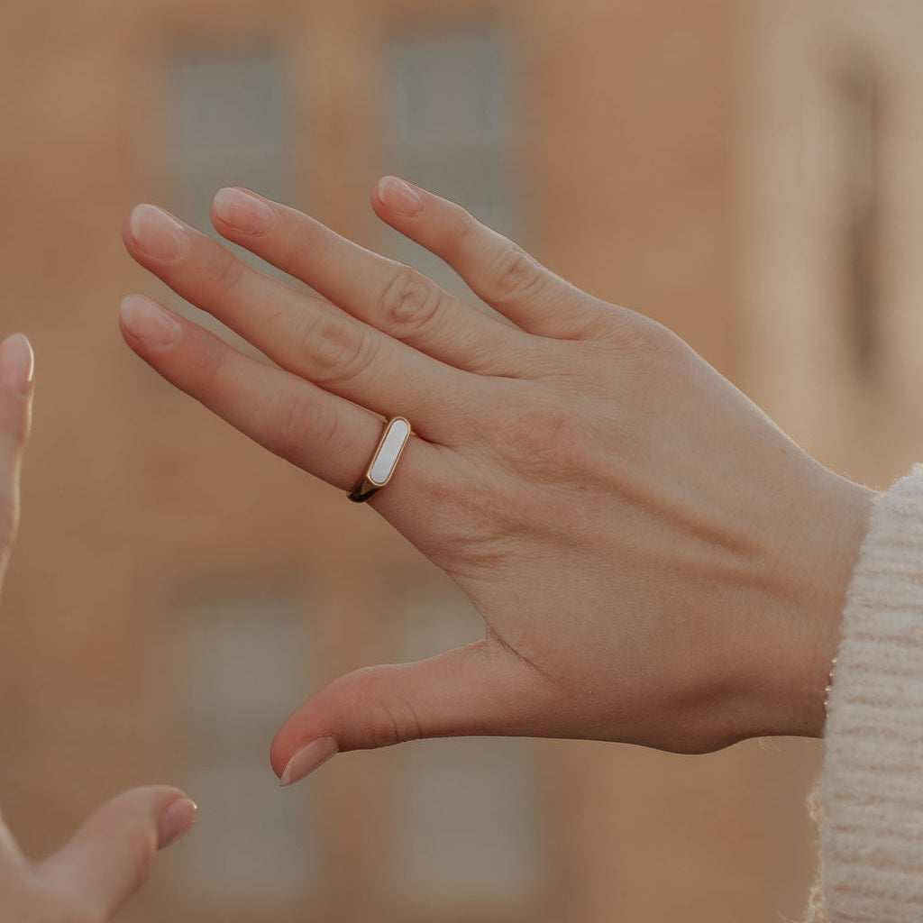 Close-up of two hands with a ring, blurred background