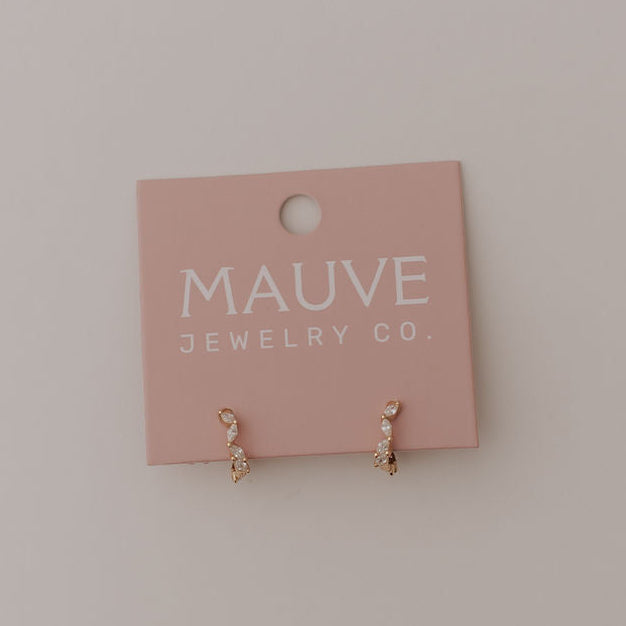 Pink jewelry card with 'MAUVE JEWELRY CO' on a light gray background featuring diamond and gold hoop earrings