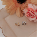 Load image into Gallery viewer, Pair of earrings on a decorative plate with flowers
