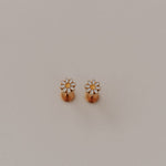 Load image into Gallery viewer, Pair of gold daisy flat back earrings on a light gray background
