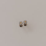 Load image into Gallery viewer, Small silver daisy flat back earrings with a floral design on a light gray background
