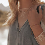 Load image into Gallery viewer, Person wearing a denim jacket with lace sleeves against a blurred natural background
