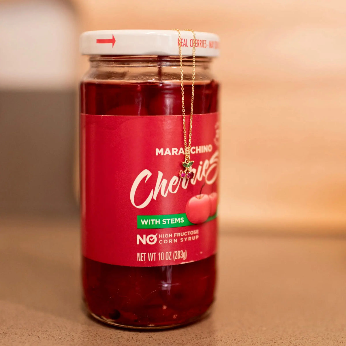 Jar of Maraschino Cherries with a red label on a wooden surface