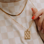 Checkered Necklace in Gold pendant necklace, gold filled, close-up of the checkerboard rectangle pendant worn layered.
