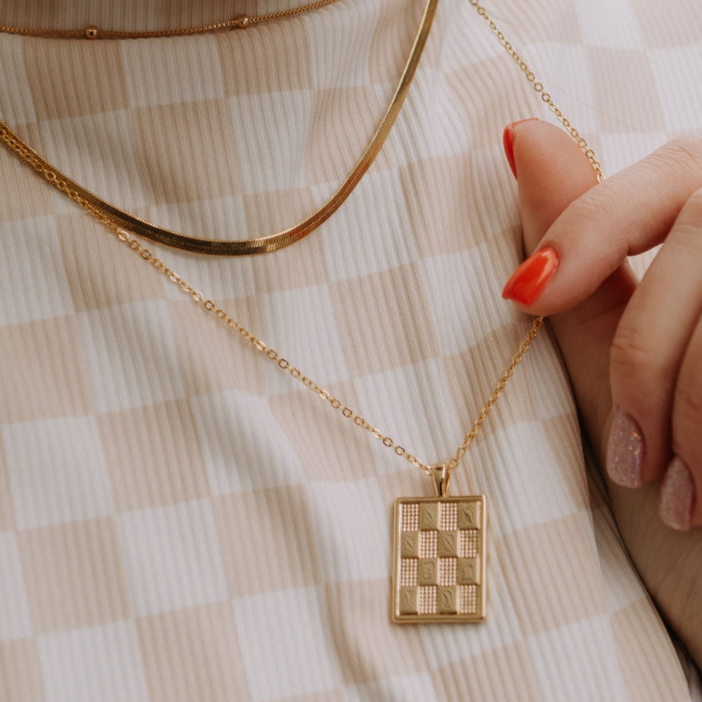 Checkered Necklace in Gold pendant necklace, gold filled, close-up of the checkerboard rectangle pendant worn layered.